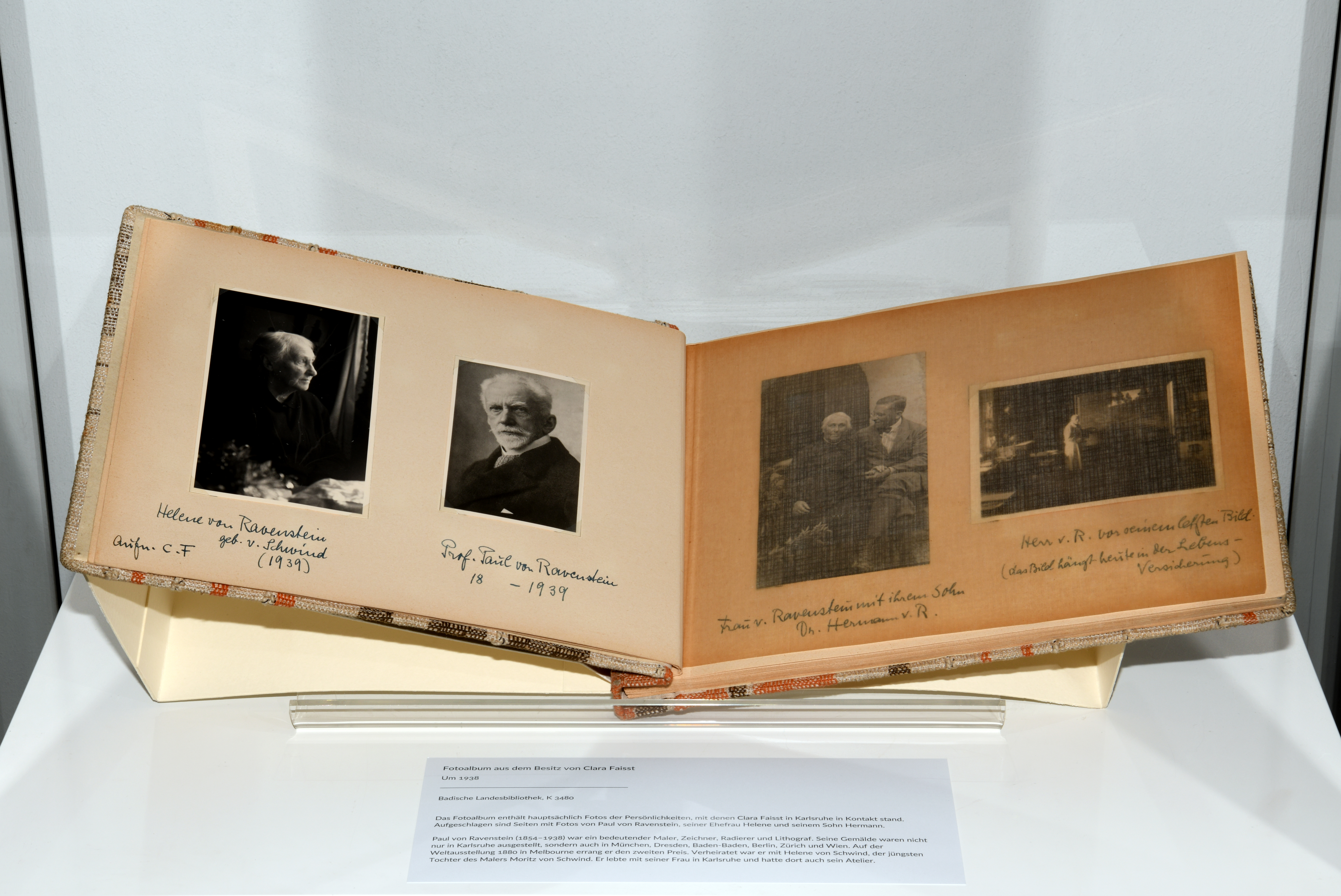 Zu sehen ist ein Fotoalbum aus dem Besitz von Clara Faisst. Die aufgeschlagenen Seiten zeigen Fotos von Paul von Ravenstein, seiner Ehefrau Helene und seinem Sohn Hermann. Paul von Ravenstein (1854–1938) war ein bedeutender Maler, Zeichner, Radierer und Lithograf aus Karlsruhe. 