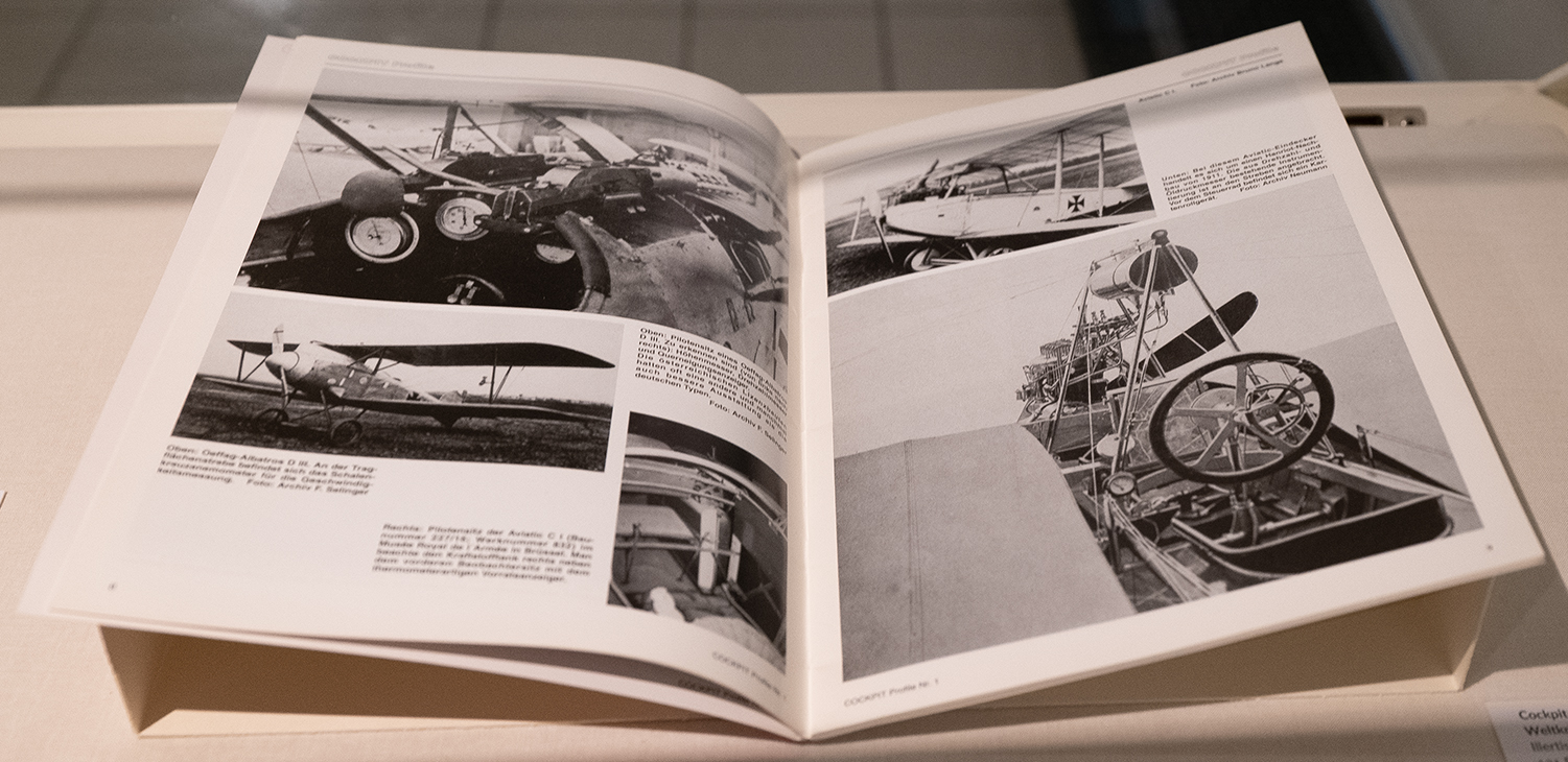 Geöffnetes Buch mit Schwarz-Weiß-Fotografien von Flugzeugen und Cockpits