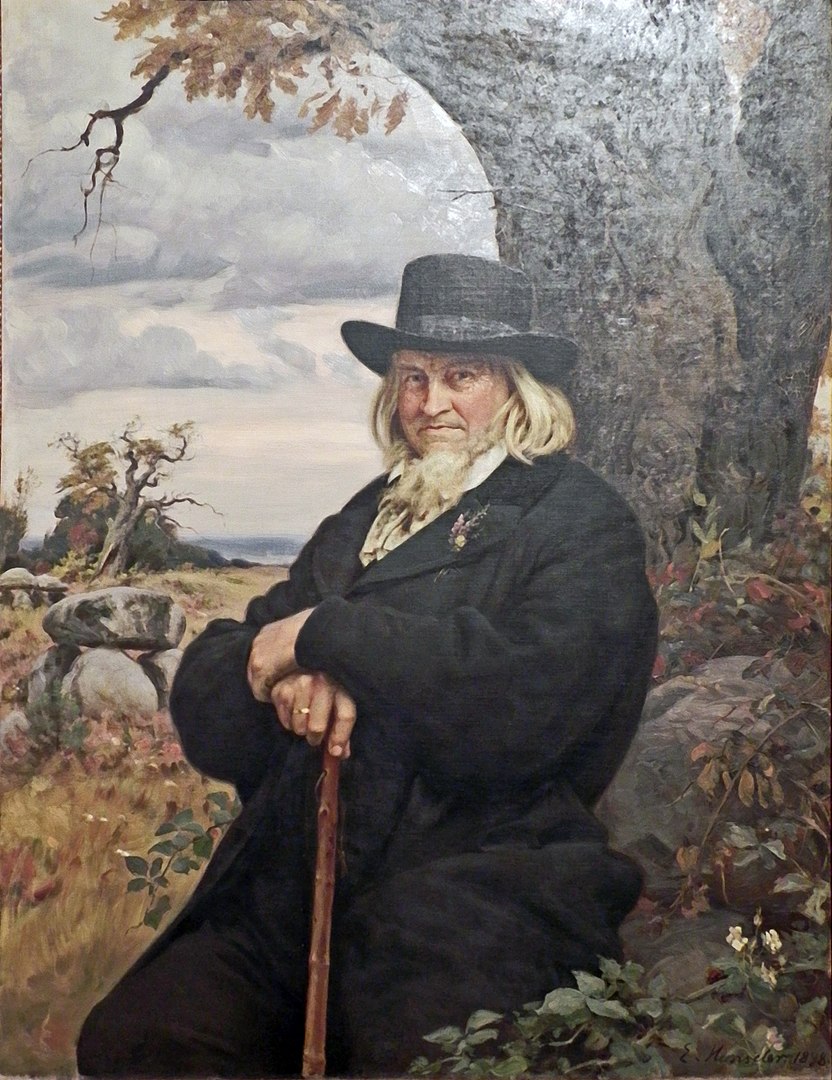 Zu sehen ist ein Gemälde von Ernst Henseler. Es zeigt Hoffmann von Fallersleben in der zeitgenössischen Mode auf einem Felsen in der Natur sitzend. In seiner Hand hält er einen Wanderstock.  