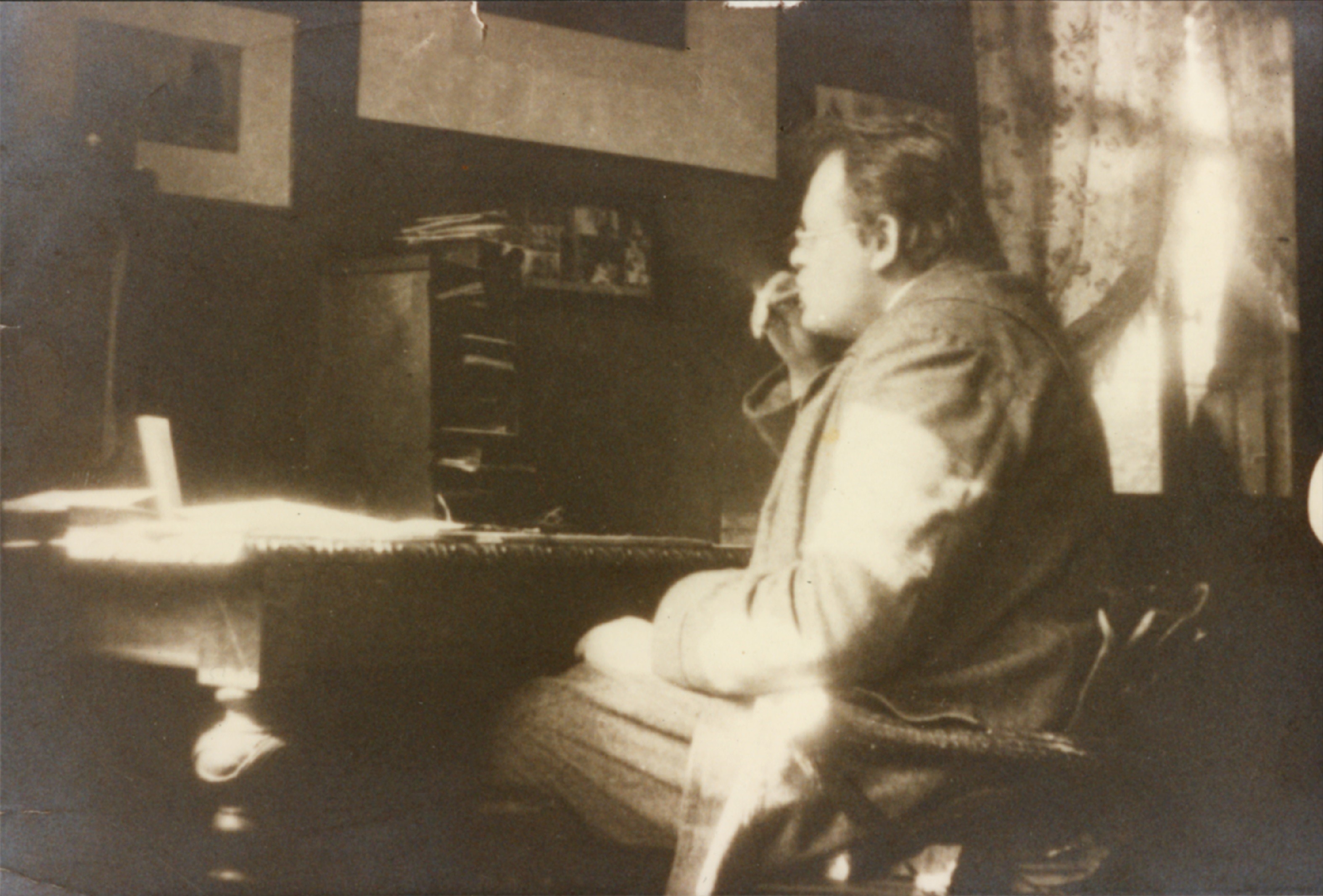 Die Schwarzweiß-Fotografie von 1908 zeigt Max Reger beim Komponieren.