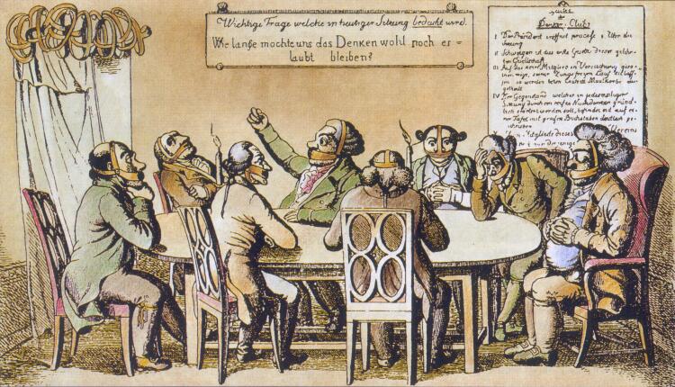 Zu sehen ist eine Karikatur von 1819. Mehrere Männer sitzen an einem Tisch und haben sprachhemmende Vorrichtungen über dem Mund. Der Mann in der Mitte hebt energisch den Arm. Eine Tafel an der Wand hinter ihnen stellt die Frage: „Wie lange möchte uns das Denken wohl noch erlaubt bleiben?“.
